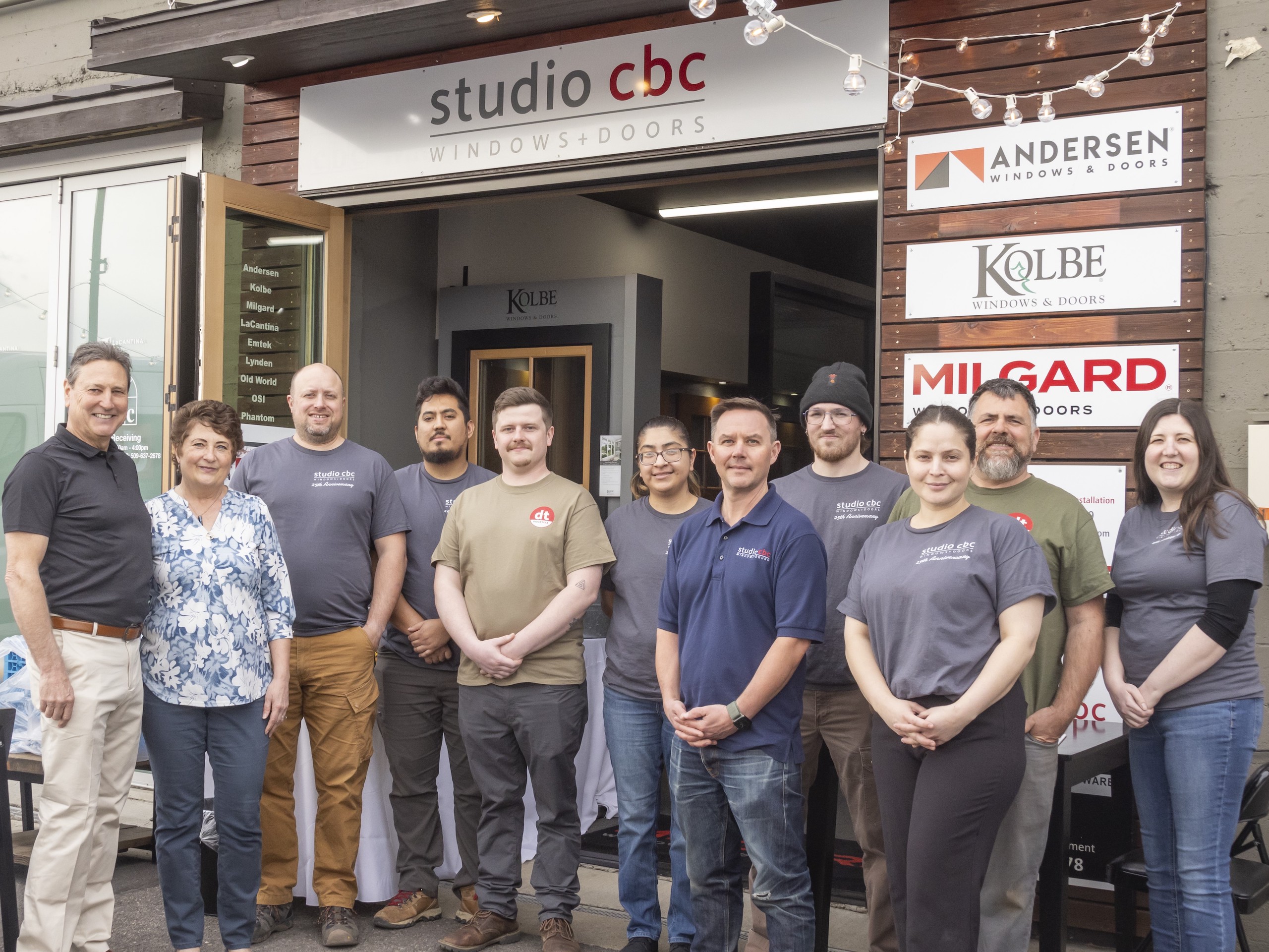 group shot of studio cbc employees standing in front of their showroom